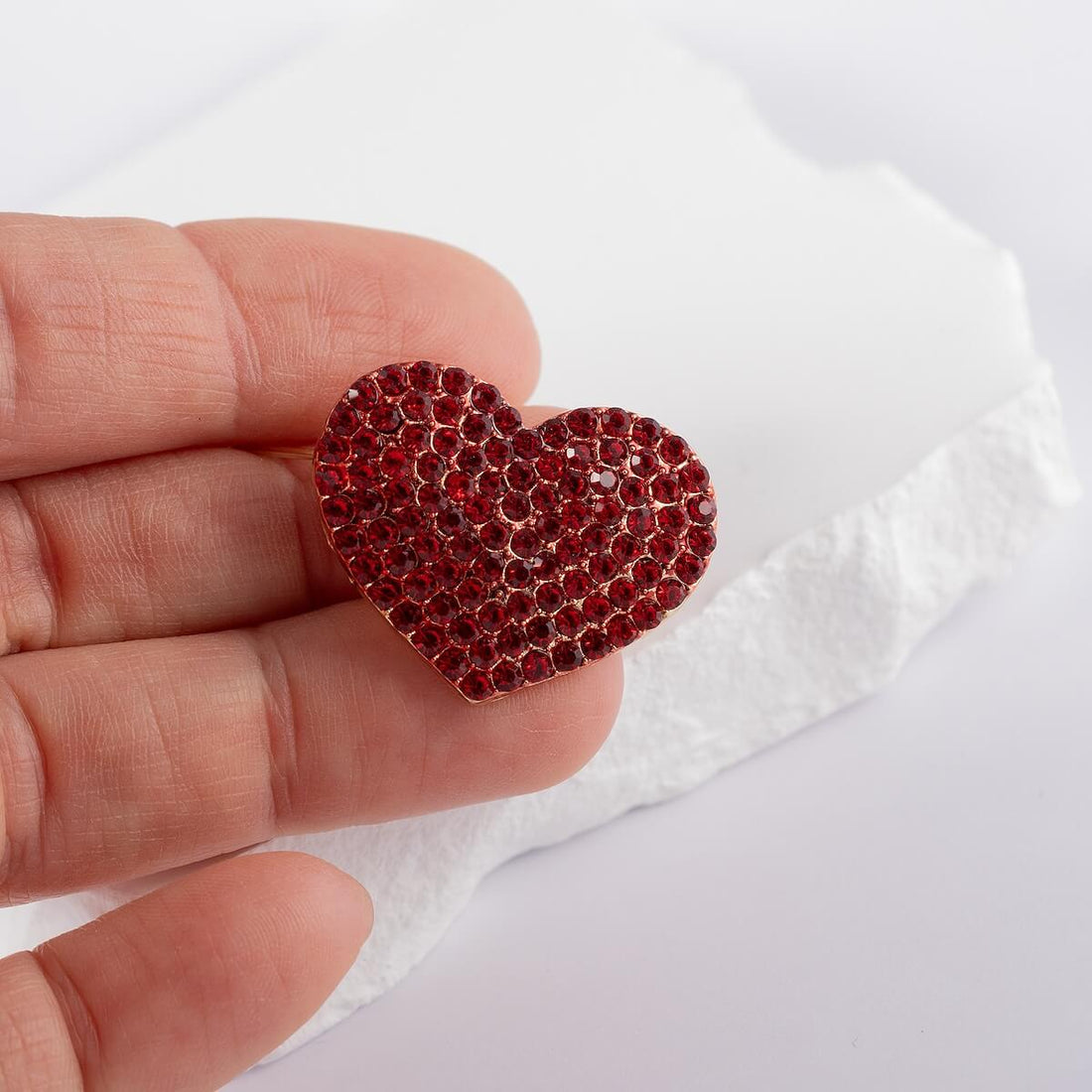 Heart-shaped brooch with crystals.